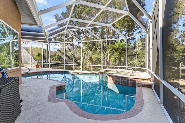 view of pool featuring glass enclosure, an in ground hot tub, and a patio