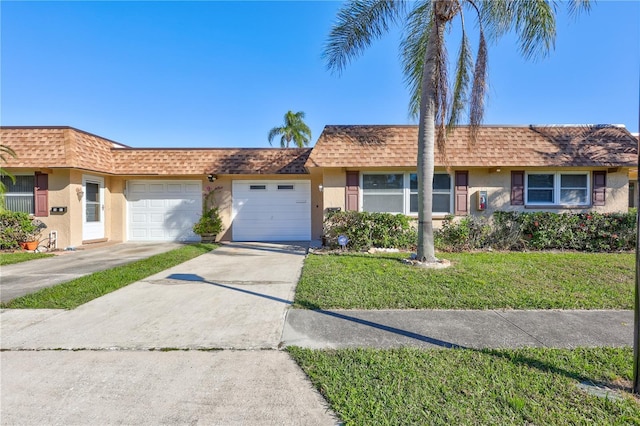 ranch-style house with a garage and a front lawn