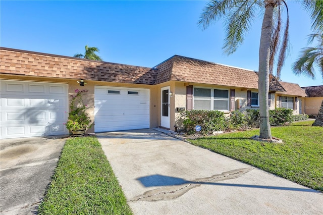 single story home with a front yard and a garage