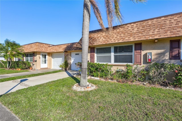 single story home featuring a front yard and a garage