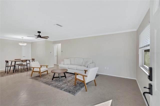 living room with ceiling fan, light tile patterned flooring, and ornamental molding