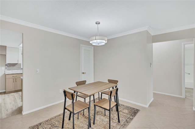 dining space featuring light tile patterned flooring and ornamental molding