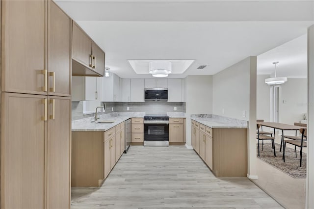 kitchen featuring appliances with stainless steel finishes, tasteful backsplash, sink, white cabinets, and light hardwood / wood-style floors