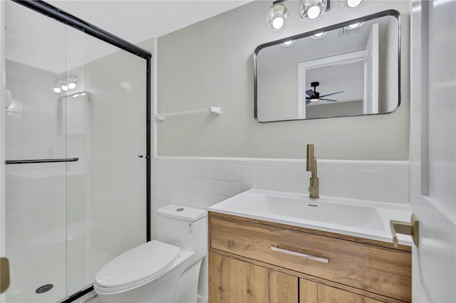 bathroom with ceiling fan, toilet, walk in shower, and vanity