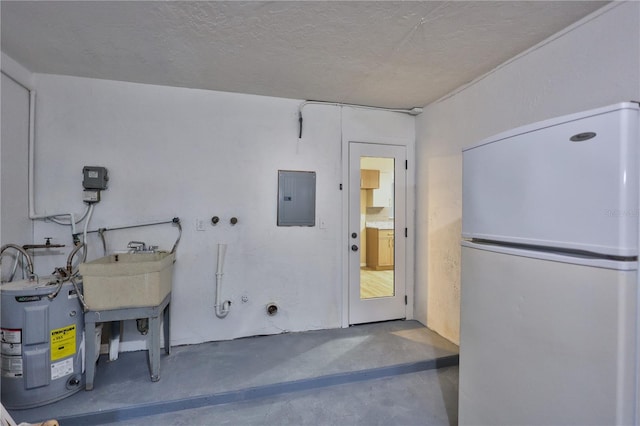 clothes washing area featuring a textured ceiling, electric water heater, electric panel, and sink