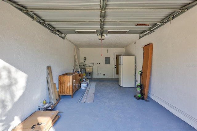 garage with electric panel and white refrigerator