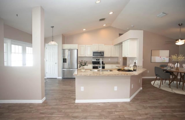 kitchen featuring light stone counters, stainless steel appliances, ceiling fan, sink, and white cabinetry