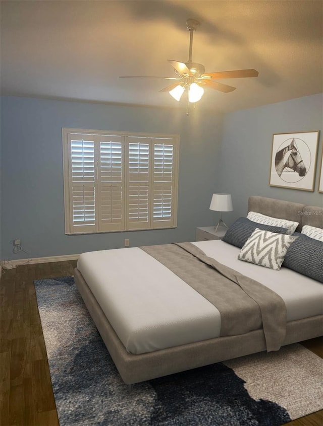 bedroom featuring hardwood / wood-style floors and ceiling fan