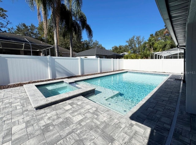 view of swimming pool with a patio area and an in ground hot tub