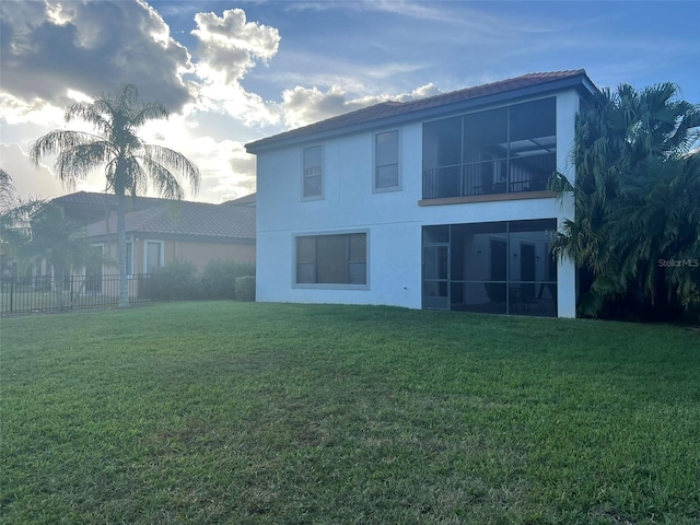 back of house with a lawn