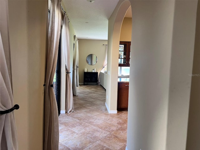 hallway featuring a textured ceiling