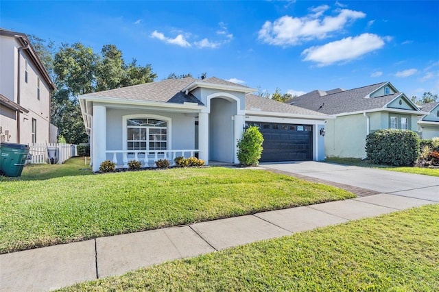 single story home featuring a front lawn and a garage