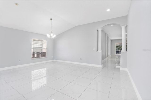 empty room with decorative columns, plenty of natural light, light tile patterned flooring, and a chandelier