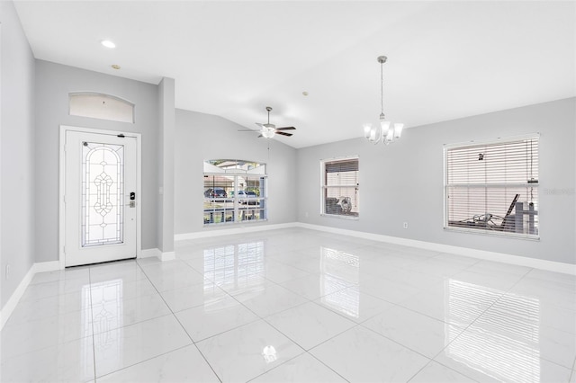 tiled foyer entrance with ceiling fan with notable chandelier