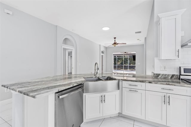 kitchen featuring dishwasher, white cabinets, sink, light stone counters, and kitchen peninsula