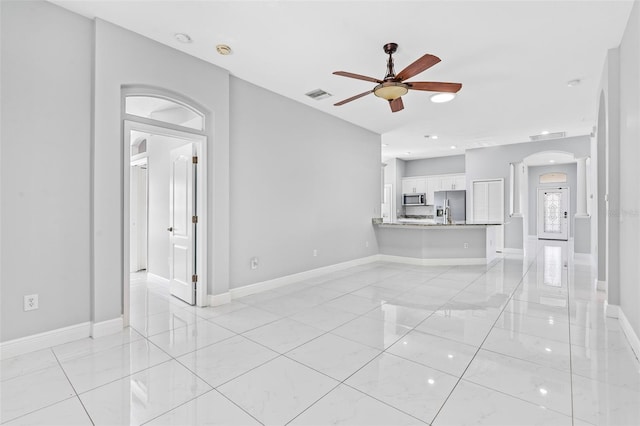 unfurnished living room with ceiling fan