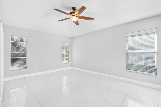 empty room featuring ceiling fan and light tile patterned flooring