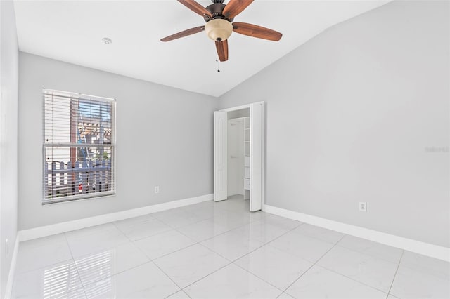 tiled spare room with ceiling fan and lofted ceiling