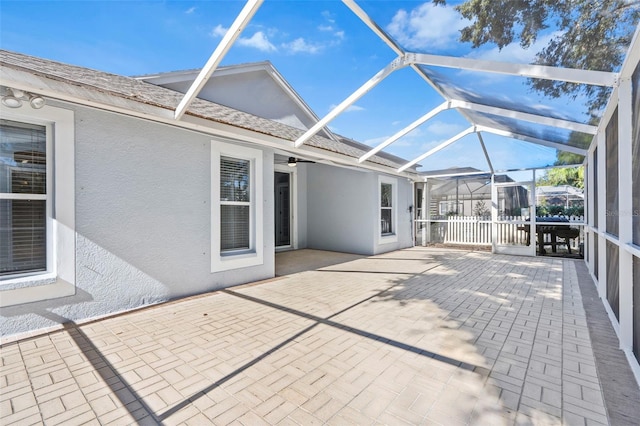 view of patio / terrace featuring glass enclosure