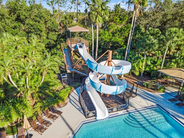 view of pool with a patio area and a water slide