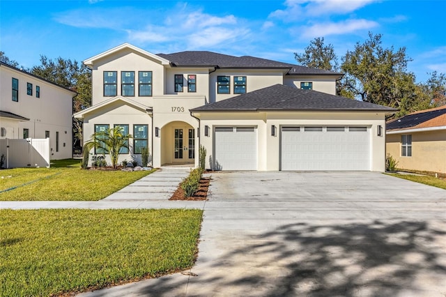 view of front of home with a garage, a front yard, and french doors