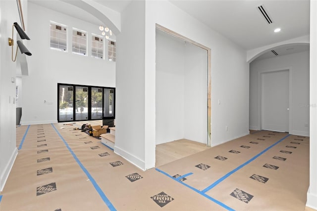 foyer entrance featuring a towering ceiling