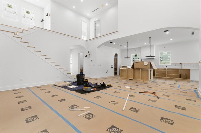 unfurnished living room with a high ceiling