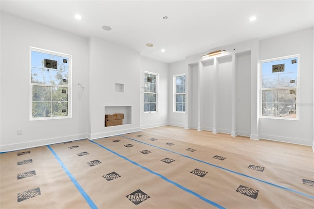 unfurnished living room with plenty of natural light