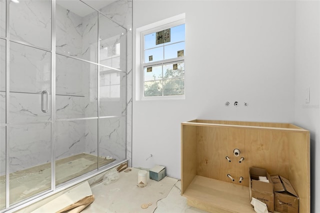 bathroom with a shower with door