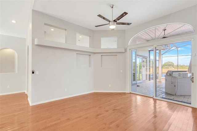 unfurnished living room with ceiling fan and light hardwood / wood-style floors