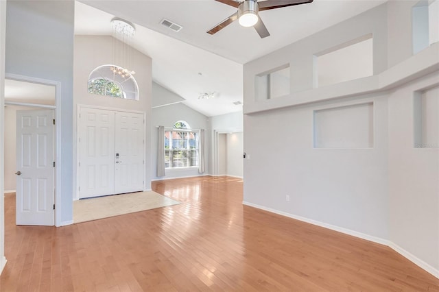 entryway featuring high vaulted ceiling, ceiling fan with notable chandelier, and light wood-type flooring