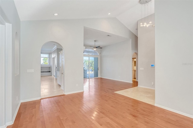 spare room with ceiling fan, light hardwood / wood-style flooring, and high vaulted ceiling