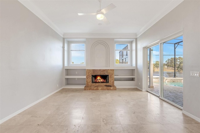 unfurnished living room with ceiling fan, ornamental molding, and a high end fireplace