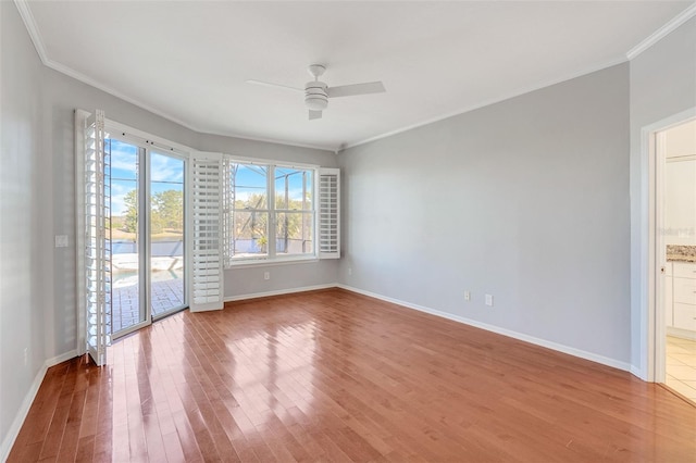 spare room featuring crown molding, ceiling fan, and wood-type flooring