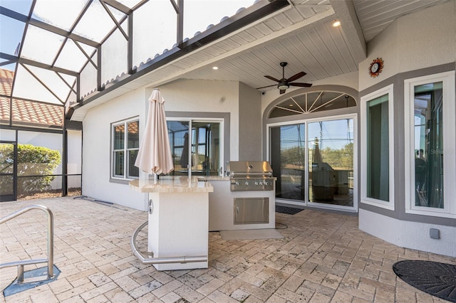 view of patio / terrace with ceiling fan, grilling area, and glass enclosure