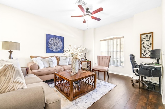 living room with dark wood-type flooring and ceiling fan