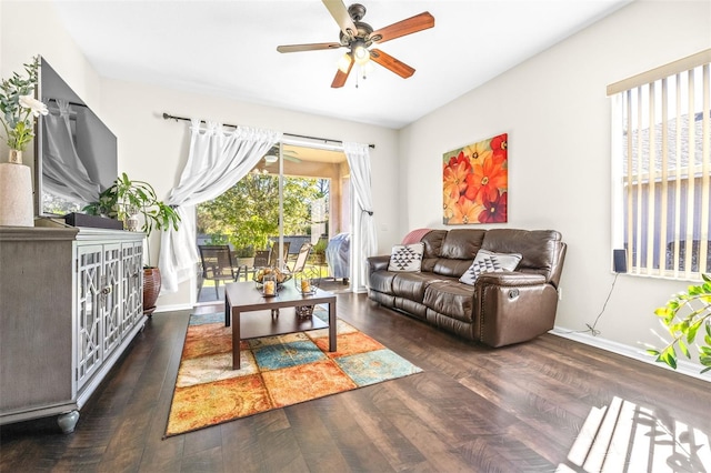 living room with dark wood-type flooring and ceiling fan