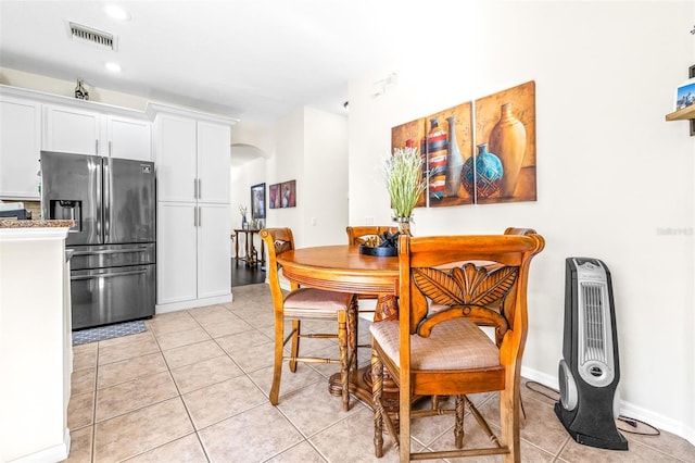 dining space featuring light tile patterned flooring