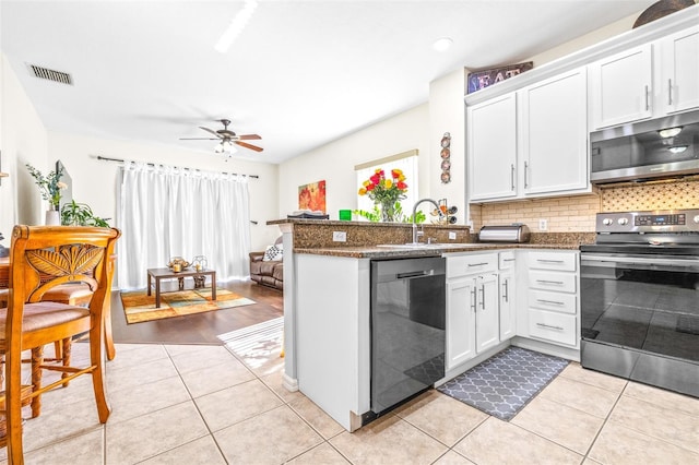 kitchen featuring white cabinetry, stainless steel appliances, sink, and light tile patterned floors