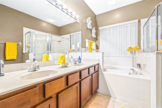 bathroom with tile patterned flooring, vanity, and plus walk in shower