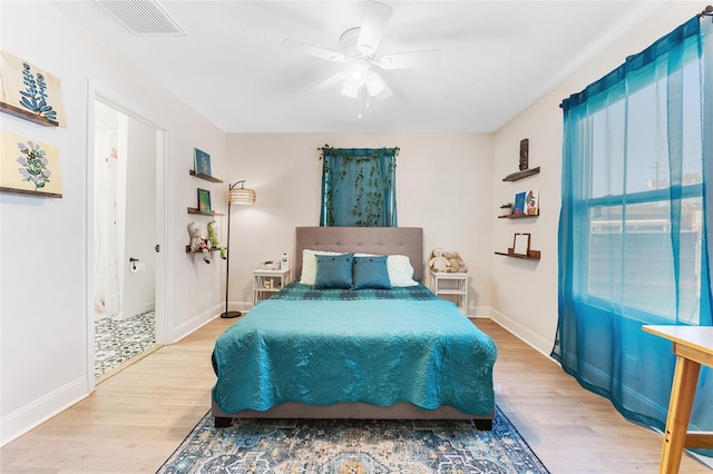 bedroom featuring visible vents, wood finished floors, and baseboards