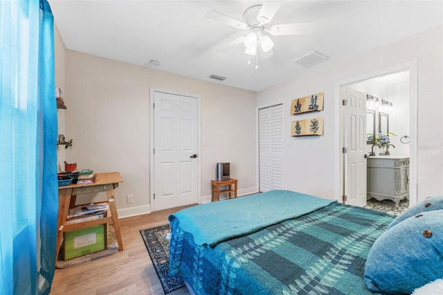 bedroom featuring wood finished floors, visible vents, a ceiling fan, and baseboards