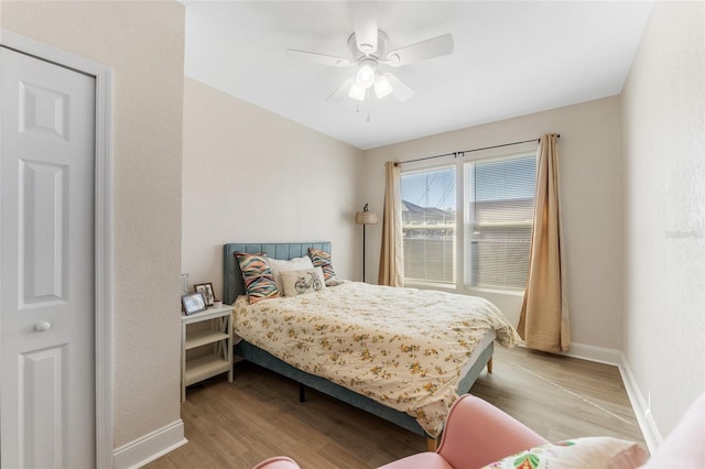 bedroom featuring wood finished floors, ceiling fan, and baseboards