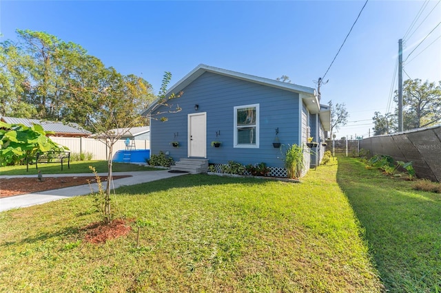 bungalow with a front lawn and fence