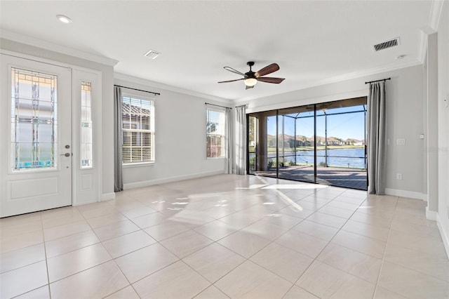 spare room featuring ceiling fan, a water view, ornamental molding, and light tile patterned floors