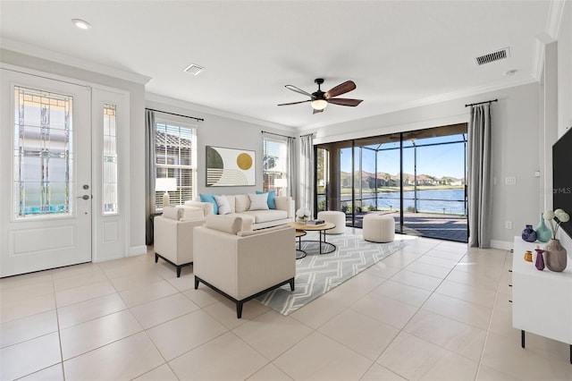 living room featuring crown molding, a water view, light tile patterned flooring, and ceiling fan