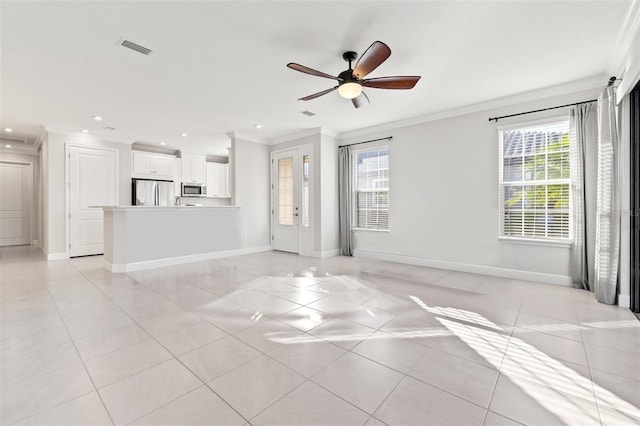 unfurnished living room featuring light tile patterned floors, crown molding, and a healthy amount of sunlight