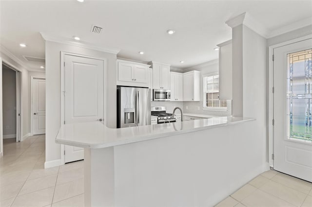 kitchen with white cabinetry, light tile patterned floors, kitchen peninsula, and appliances with stainless steel finishes