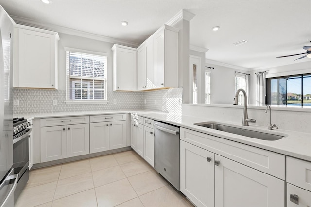 kitchen with white cabinets, plenty of natural light, sink, and stainless steel appliances