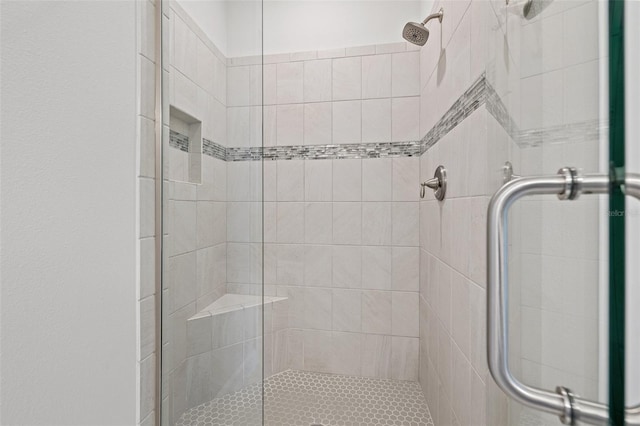 bathroom with a shower with shower door